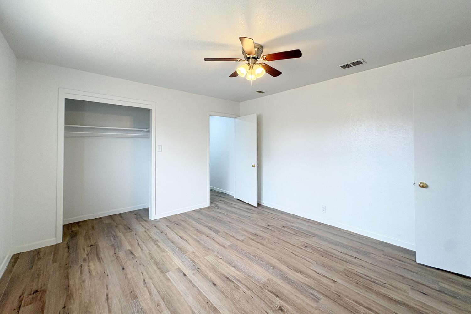 809 West 5th Street Wolfforth, TX 79382 - Photo 10 of 23 a view of empty room with wooden floor