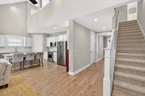 a view of kitchen with refrigerator stove and wooden cabinets