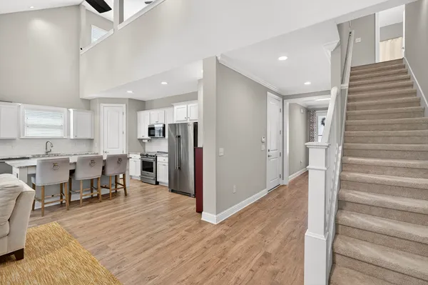 a view of kitchen with refrigerator stove and wooden cabinets