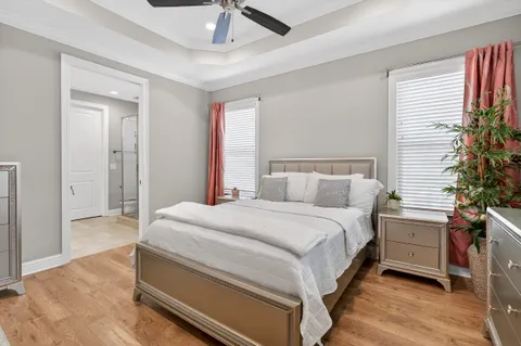 a spacious bedroom with a bed and a potted plant