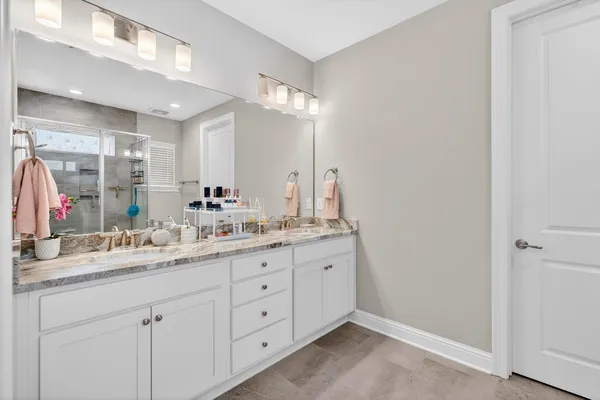 a bathroom with a double vanity sink and a mirror
