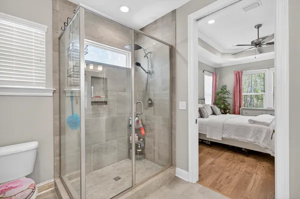 a en suite bathroom with a glass door shower and a toilet