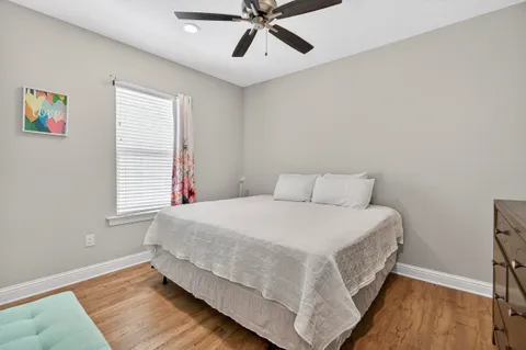 a bed sitting in a bedroom next to a window