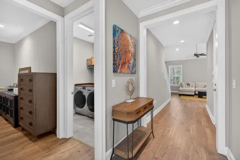 a view of a hallway with workspace and a couch