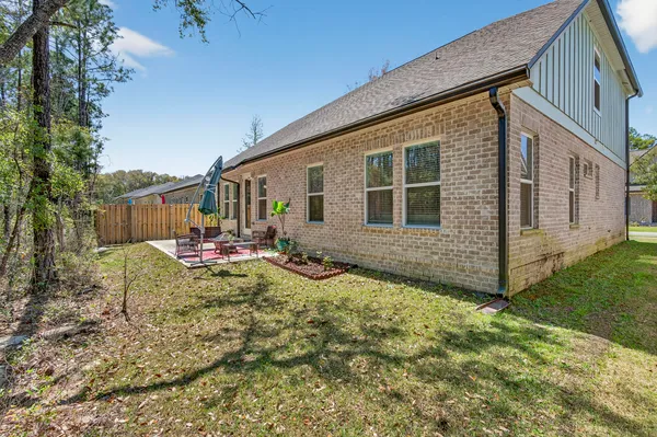 a view of a house with backyard and sitting area