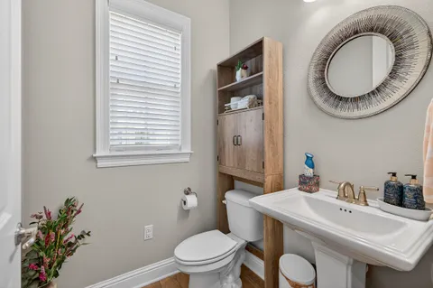 a bathroom with a toilet a sink and a mirror