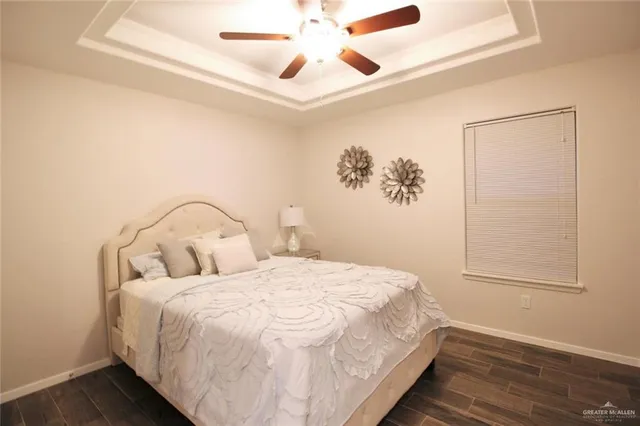 a large bed sitting in a bedroom next to a window