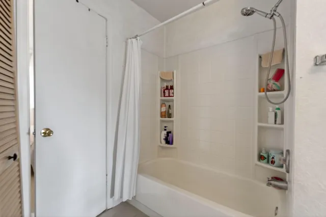 a bathroom with a bathtub and a shower