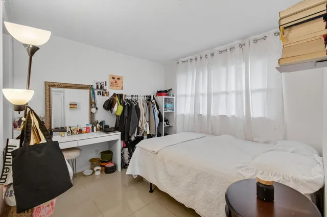 a bedroom with a bed and a closet