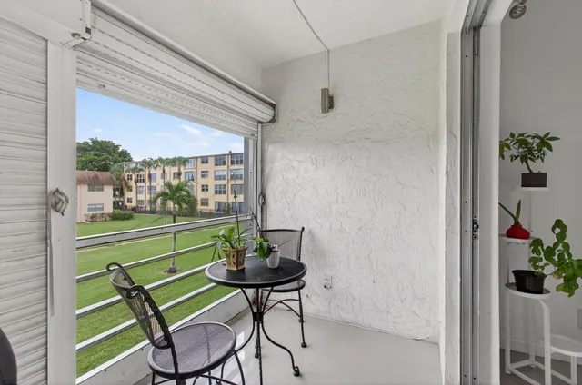 a view of a porch with furniture and a yard