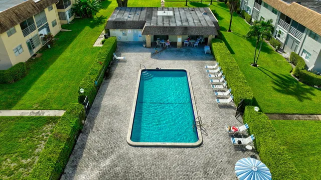 a front view of a house with a garden and plants