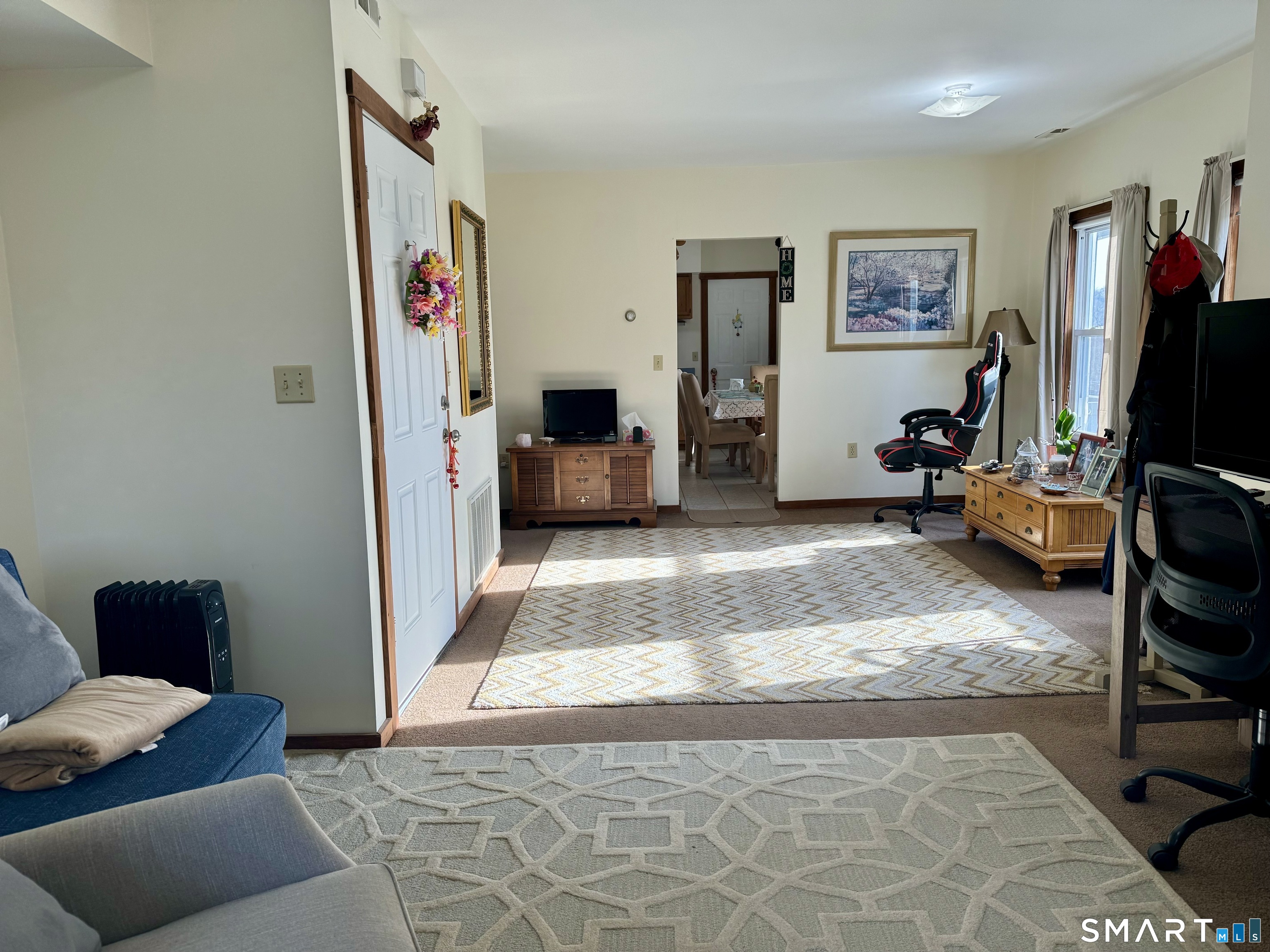 a living room with furniture and a flat screen tv