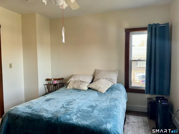 a bedroom with a bed and window