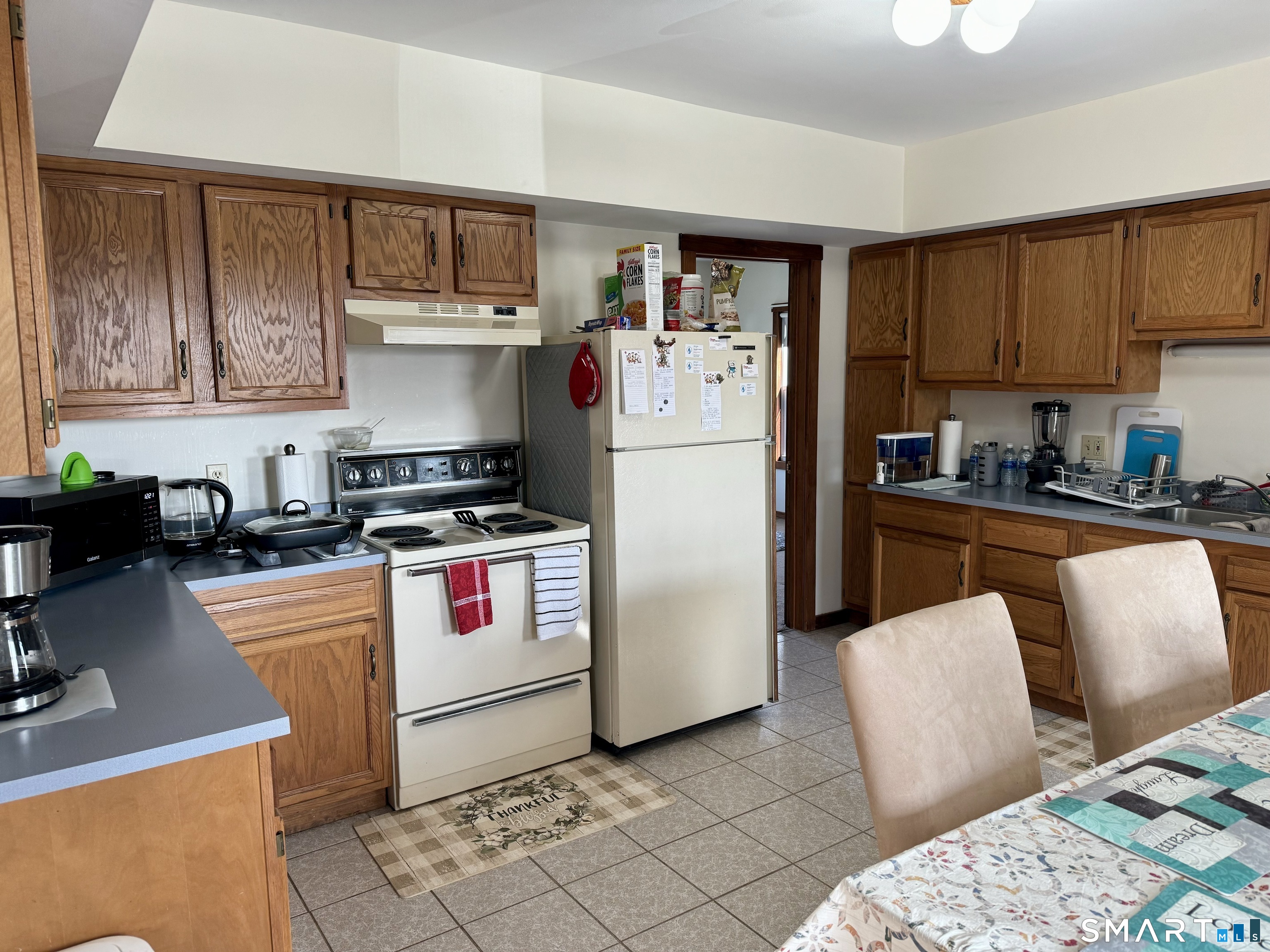 156 Fair Street, Unit 2 Wallingford, CT 06492 - Photo 6 of 15 a kitchen with stainless steel appliances granite countertop a refrigerator sink and stove