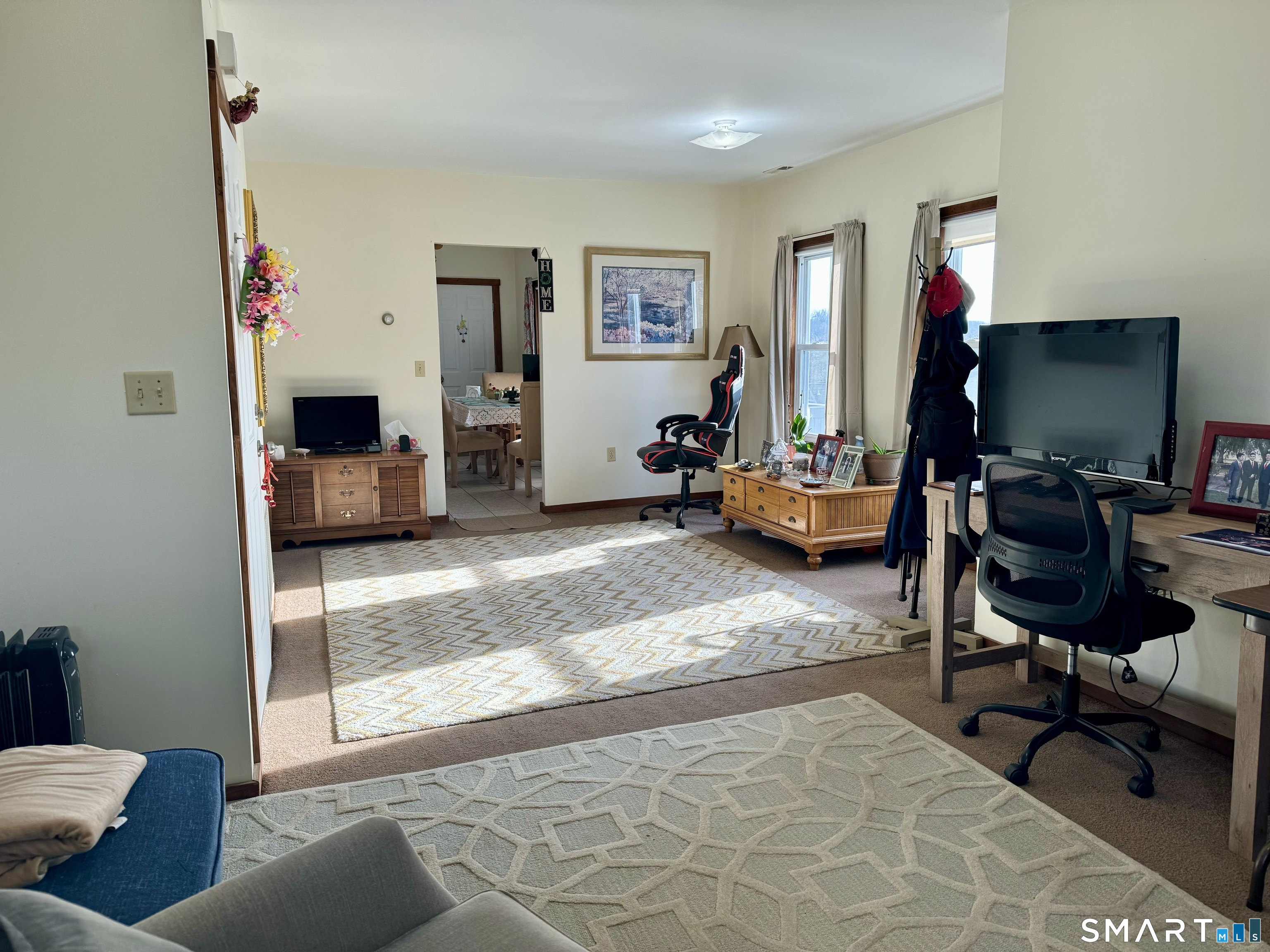 156 Fair Street, Unit 2 Wallingford, CT 06492 - Photo 9 of 15 a living room with furniture and a flat screen tv