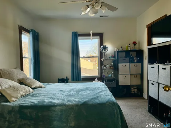 a bedroom with a bed and a television