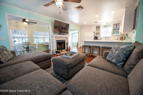 a dining room with furniture and wooden floor