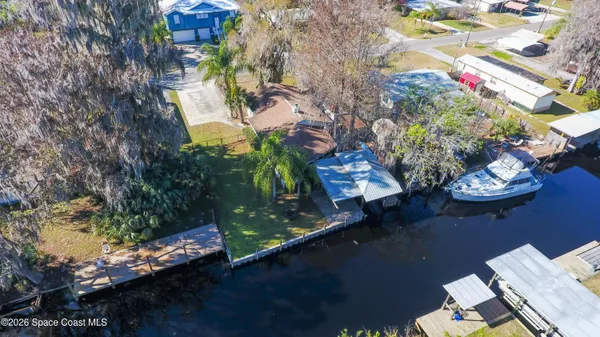a view of a yard with cars on road