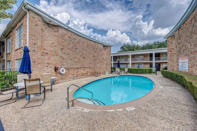 a view of a swimming pool with a patio