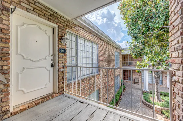 a view of balcony with wooden floor and fence