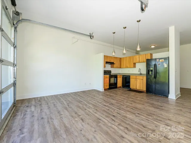 a view of a room with wooden floor