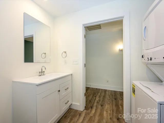 a bathroom with a sink a mirror and a shower