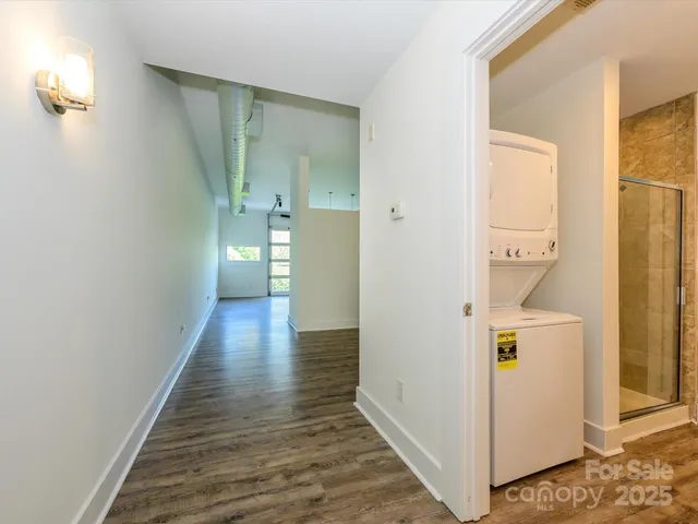 a view of hallway with wooden floor