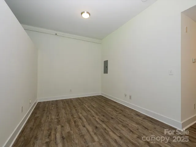 a view of room with wooden floor and fan