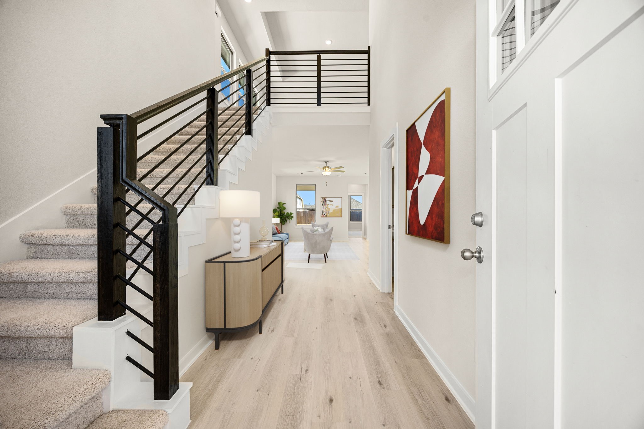 1128 Lilly Lane Bellville, TX 77418 - Photo 6 of 25 The stunning two-story entryway offers a grand, modern welcome into the home. This bright space immediately captures attention with its soaring ceilings and contemporary design elements. *Virtually Staged