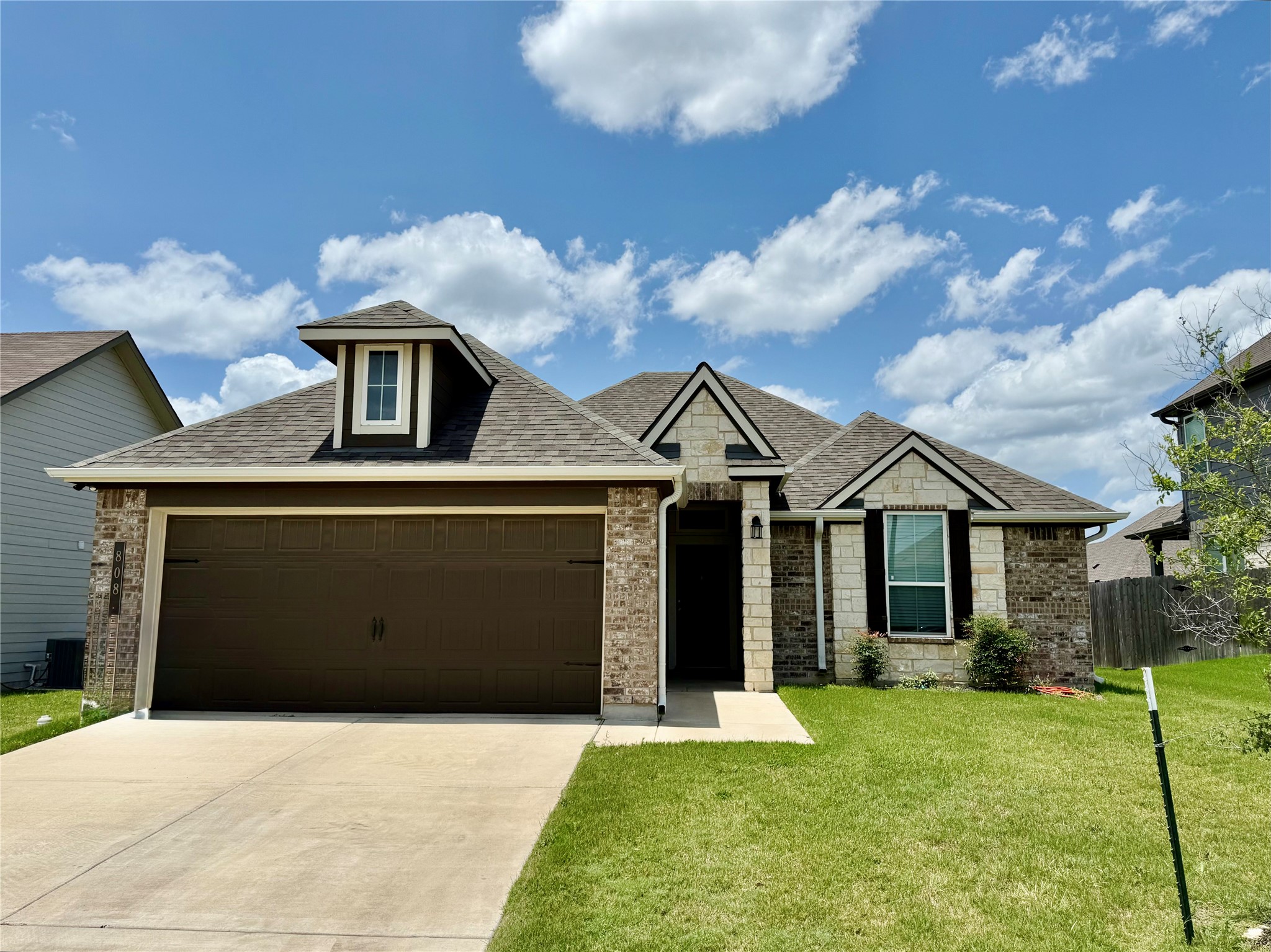 808 Fallbrook Drive Temple, TX 76502 - Photo 1 of 36 View of front of property featuring a garage, concrete driveway, a shingled roof, stone siding, and brick siding
