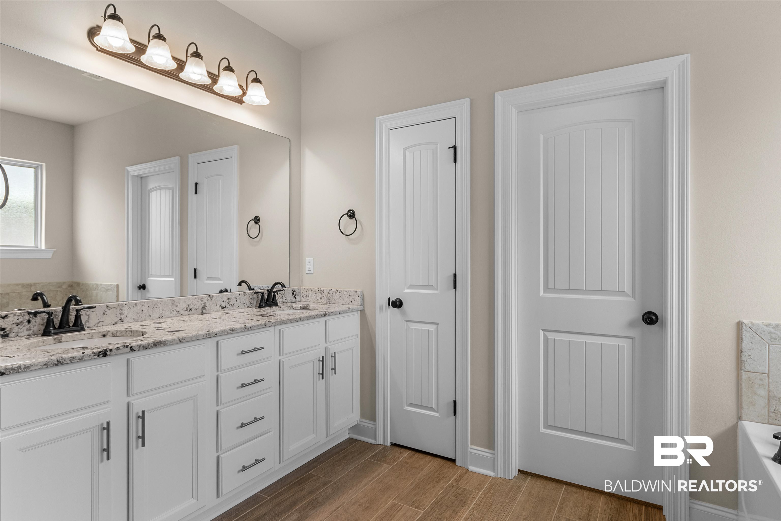 991 Dalton Circle Foley, AL 36535 - Photo 21 of 35 Full bathroom featuring double vanity, wood finished floors, and a bathtub