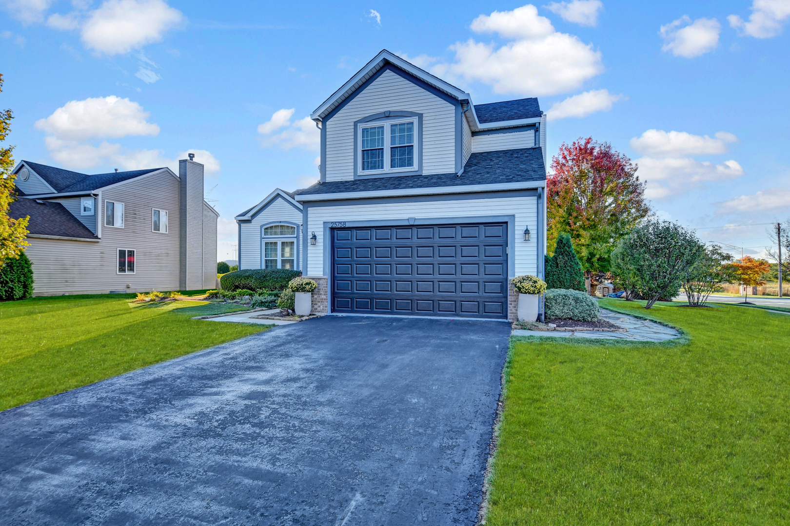 25758 South Basswood Road Channahon, IL 60410 - Photo 31 of 42 a front view of a house with a yard and garage