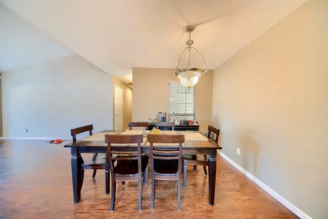 a kitchen with granite countertop stainless steel appliances wooden cabinets a stove a sink and a window