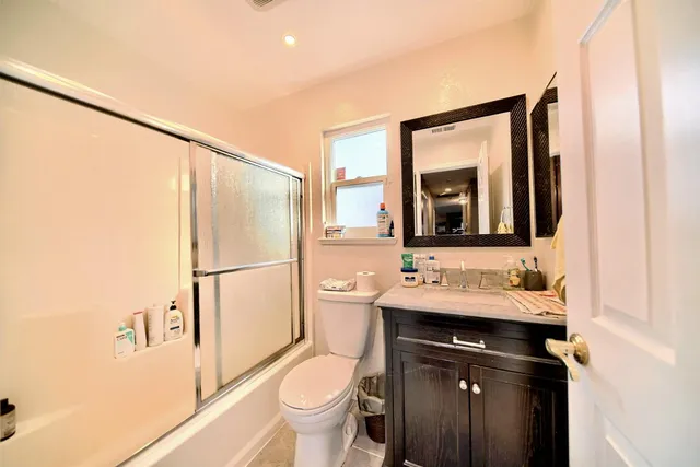 a view of a hallway with wooden floor and a small space