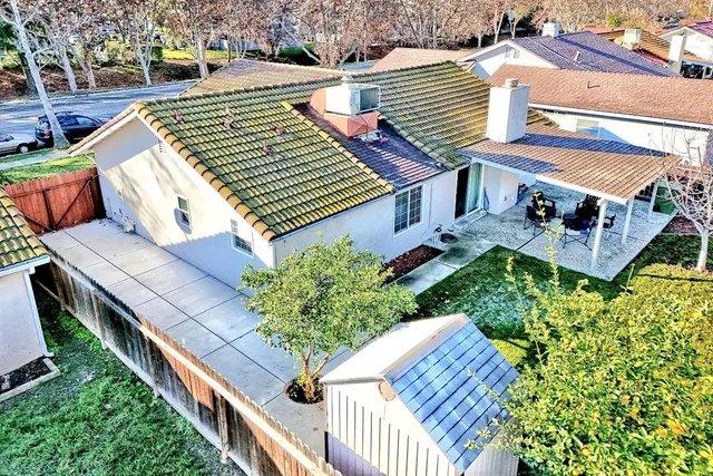 an aerial view of a house with swimming pool and outdoor seating