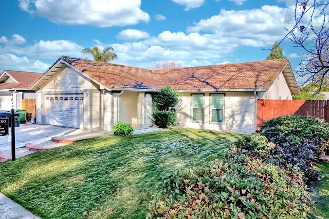 an aerial view of a house with a yard and potted plants