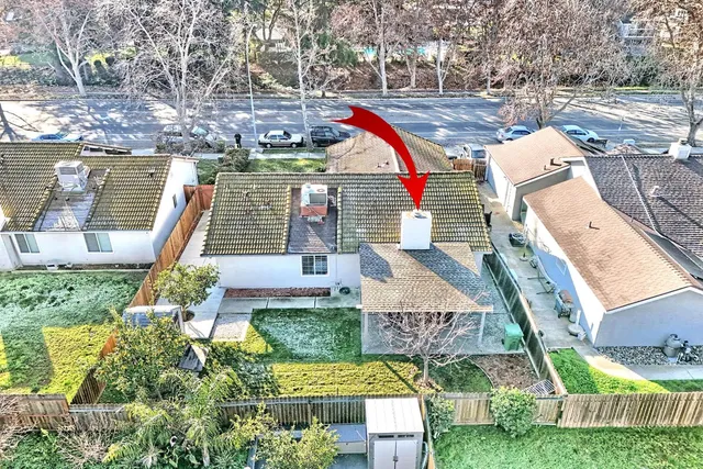 a view of a house with backyard and sitting area