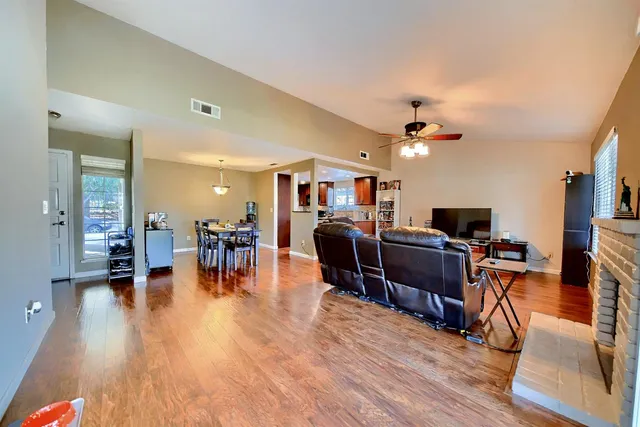 a living room with furniture and a wooden floor