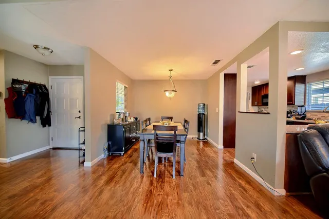 a view of a dining room with furniture window and wooden floor