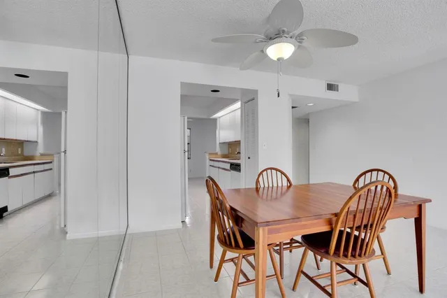 a dining room with furniture and chandelier