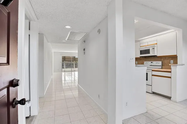 a view of kitchen with refrigerator and window