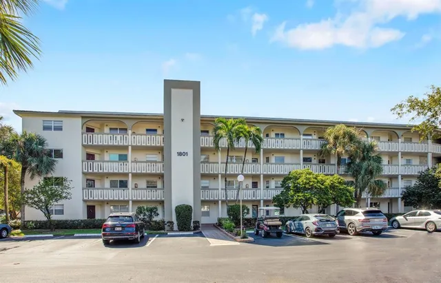 a car parked in front of a building and cars parked in front of house