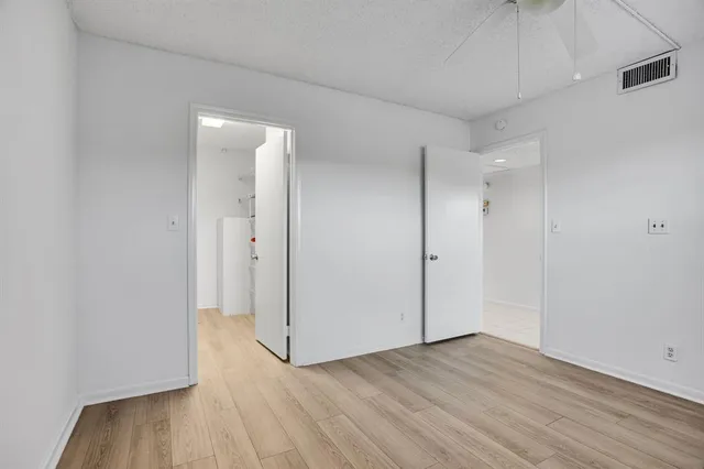 a view of hallway with wooden floor