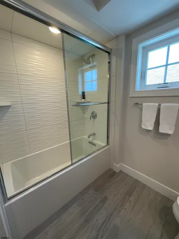 a bathroom with a bathtub and a shower