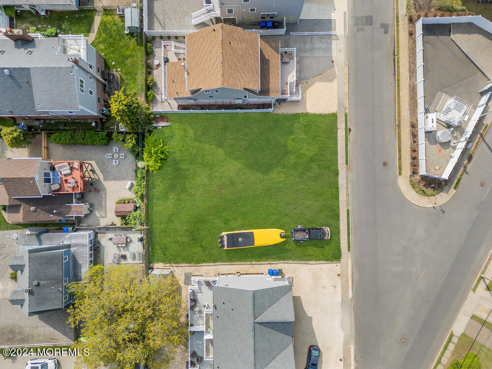 an aerial view of a house with a yard pool outdoor seating and yard