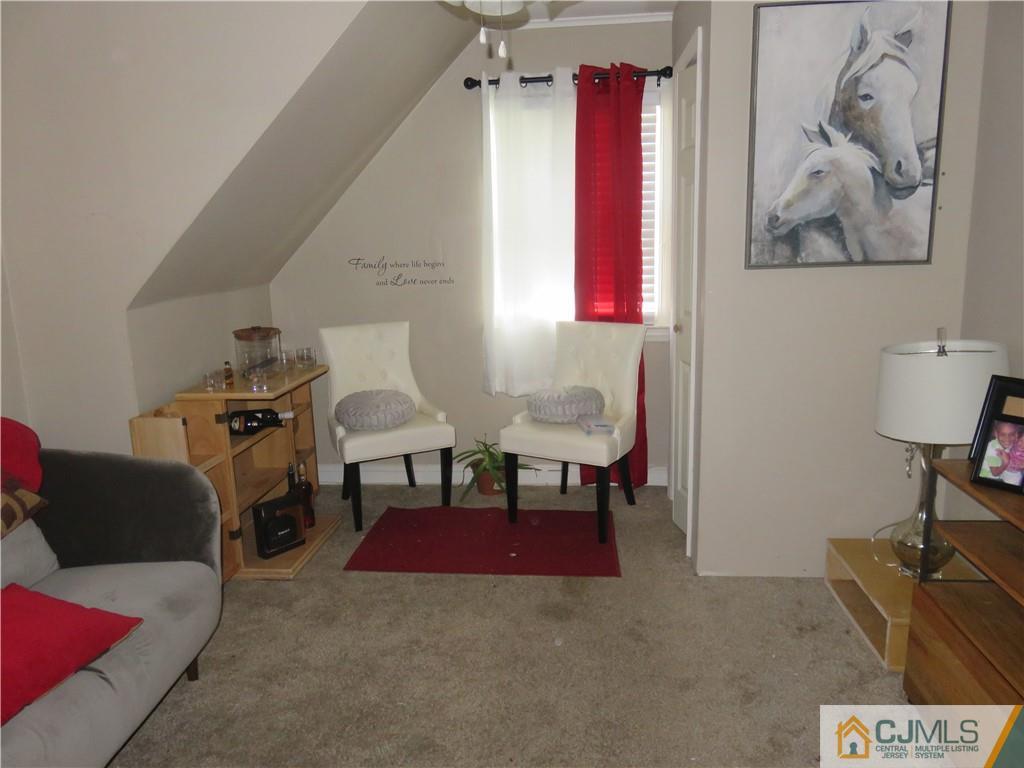 551 Colgate Avenue Perth Amboy, NJ 08861 - Photo 11 of 16 a living room with furniture and a piano