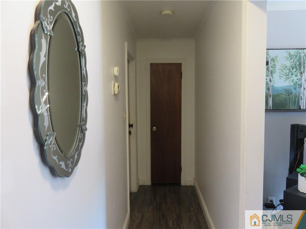 551 Colgate Avenue Perth Amboy, NJ 08861 - Photo 2 of 16 an entryway with wooden floor mirror and a bathroom view