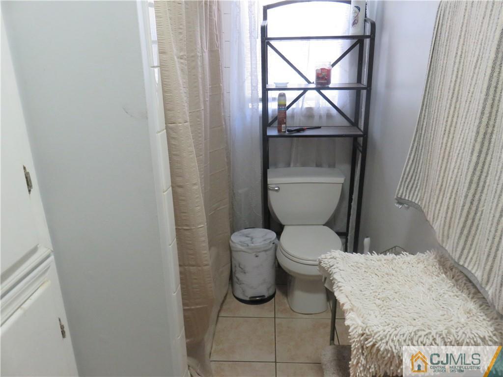 551 Colgate Avenue Perth Amboy, NJ 08861 - Photo 3 of 16 a bathroom with a toilet