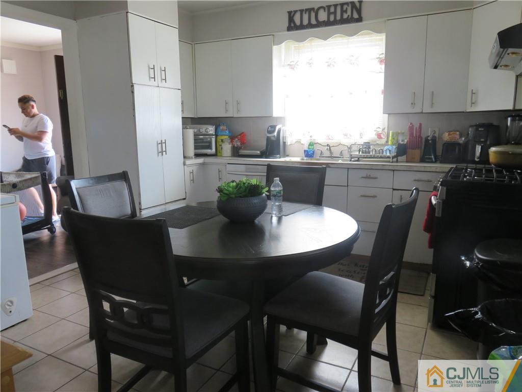 551 Colgate Avenue Perth Amboy, NJ 08861 - Photo 4 of 16 a view of a dining room with a table and chairs