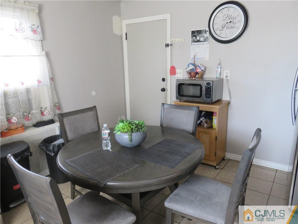 551 Colgate Avenue Perth Amboy, NJ 08861 - Photo 6 of 16 a view of a dining room with furniture and wooden floor